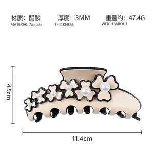 Detailed view of beige acetate flower hair claw with pearl centers and specific dimensions