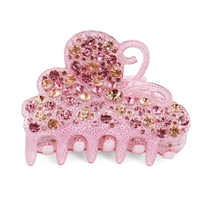 Detail of pink acrylic butterfly hair claw clip with sparkling rhinestones and resin finish