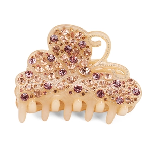 Macro detail of large acrylic butterfly hair claw with sparkling pink rhinestones