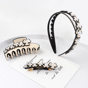 Beige acetate hair clip set with 3D floral accents and pearls in a stylish display