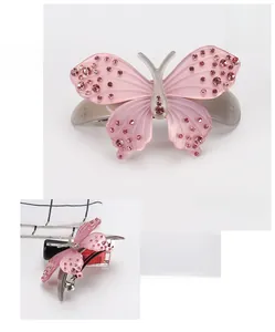 Detail view of the pink butterfly hair clip featuring sparkling rhinestones and spring mechanism