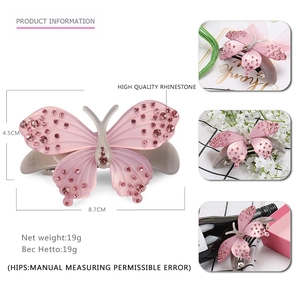 Pink butterfly hair clip with rhinestones and acetate finish measuring 8.7cm in length