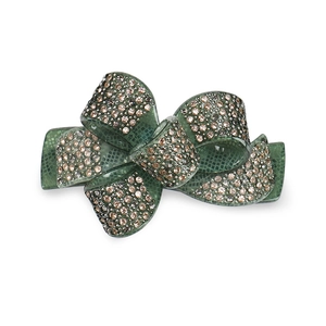 Macro detail of acrylic bow hair clip with dark green grid texture and sparkling rhinestones