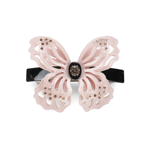 Detail of hollow pink acetate butterfly hair clip with sparkling rhinestones decoration