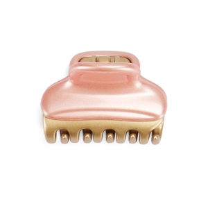 Detail view of the pearl pink resin finish and matte gold teeth of the acrylic hair claw