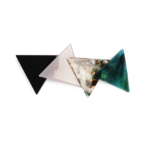Geometric triangular acetate hair clips in black, pink, tortoiseshell, and marble teal colors