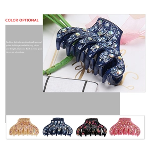 Detail of handcrafted acrylic hair claw clip featuring high-shine rhinestone embellishments