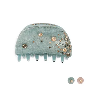 Blue acrylic round claw clip with sparkling rhinestones and brushed finish texture