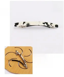 Detail view of black and white acetate spring hair clip measuring 8.5 by 0.7cm