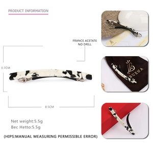 Detail showing marble texture acetate hair clip with dimensions and premium packaging