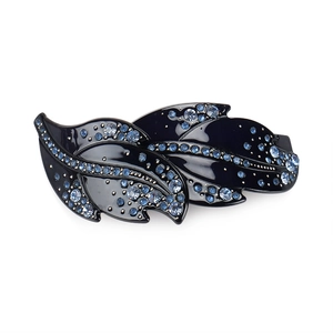 Detailed macro view of acrylic leaf hair clip with blue rhinestones on black base