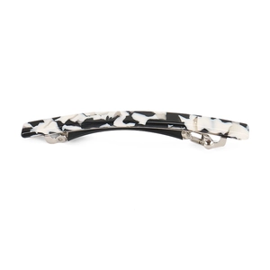 Detail of black and white marble acetate hair clip with silver metal spring buckle