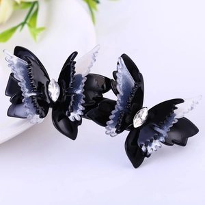Détail macro d'une barrette papillon double avec strass et finition pailletée