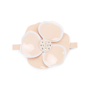 Close-up of pink camellia hair clip with white edges and sparkling crystal center