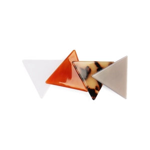 Macro detail of geometric triangular hair clips in tortoiseshell and marble acetate finish