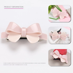 Detailed views of a pink acetate bow hairpin showing polished finish and spring clip detail