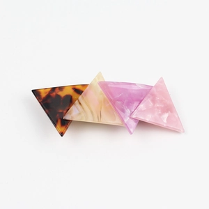 Detail of geometric acetate hair clip with tortoiseshell and marble texture patterns