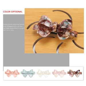 Elegant bow-shaped acetate hair clip with marble texture and metal spring clasp for women
