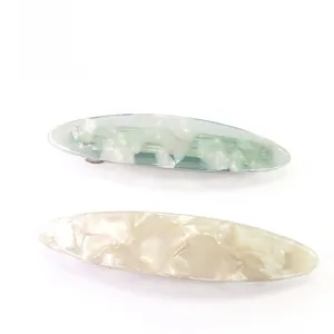 Close-up of elegant marble pattern acetate hair clips with metallic spring closure
