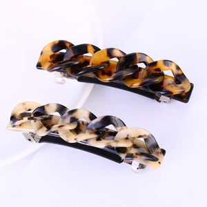 Close-up of tortoise shell pattern acetate chain hair clips in dark brown and beige grey