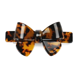 Detailed view of large tortoise shell acetate bow hair clip with smooth glossy finish