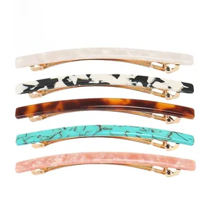 Detailed set of five acetate triangle hair clips in pearl, marble, and tortoise textures