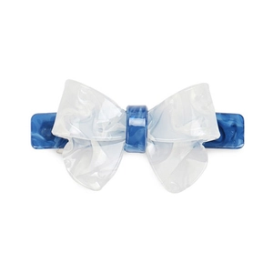 Detailed macro view of the marble-textured acetate bow hair clip with blue patterns