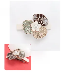 Close-up of elegant acetate flower hair clip with pearl center and crystals, 8.5x6cm