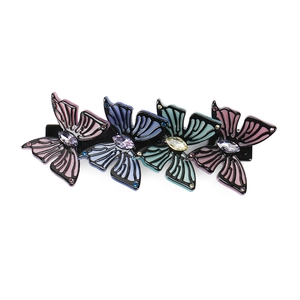 Detailed macro view of acetate butterfly hair clips with sparkling crystals in mixed colors