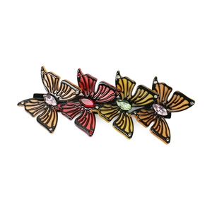 Close-up of four colorful acetate butterfly hair clips with sparkling crystal rhinestones