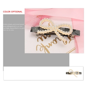 French bow hair clip with white artificial pearls and snakeskin pattern spring base