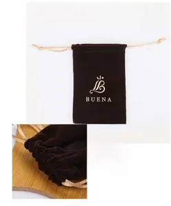 Detail view of dark brown velvet jewelry pouch with golden logo and 15x10cm dimensions