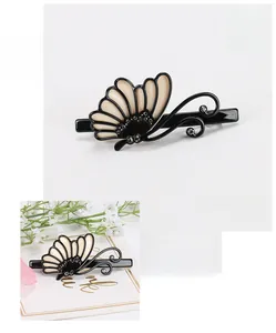 Detail view of acetate butterfly hair clip with crystals and elegant floral props