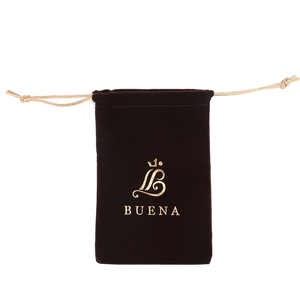 Detail view of premium dark brown velvet drawstring jewelry pouch with golden logo