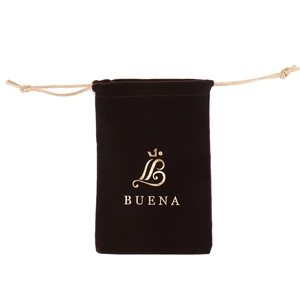 Deep brown velvet jewelry pouch with golden crown logo and drawstring closure
