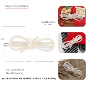 Elegant ivory white acetate bow hair clip with marble texture and metal base