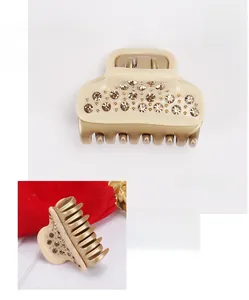 Detail view of French acetate hair claw with hand-set crystals and gold accents