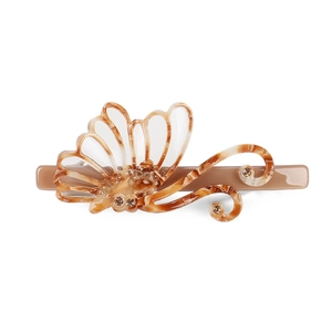 Detail of tortoise shell butterfly hair clip with sparkling crystals on polished acetate