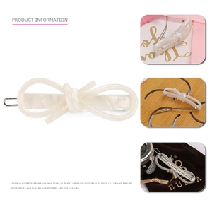 Elegant cream white acetate bow hair clip shown in multiple angles on a clean background