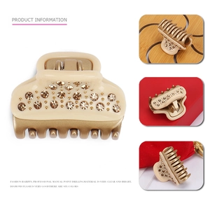 Classic hair claw clip in beige and gold finish with sparkling crystals on white background