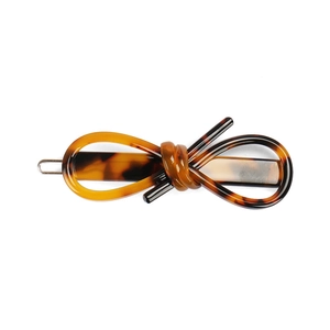 Close-up of tortoiseshell acetate hair clip with a stylish infinity knot design