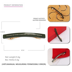 Deep green acetate hair clip with crystal inlay and gold spring clasp on white background
