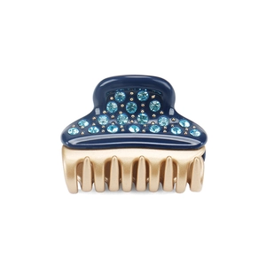 Macro shot of dark blue acetate hair claw with sparkling rhinestones and gold teeth
