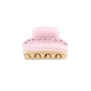 Dettaglio della piccola molletta per capelli rosa in acetato con fila di strass