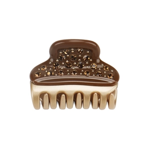 Close-up of brown acetate hair claw clip with rhinestones and champagne gold metal teeth