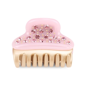 Detail of pink crystal hair claw clip with golden teeth and shimmering rhinestones