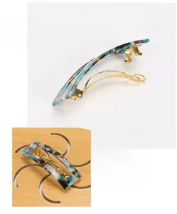 Detailed view of rectangle marble acetate hair clip with golden metal spring clip mechanism