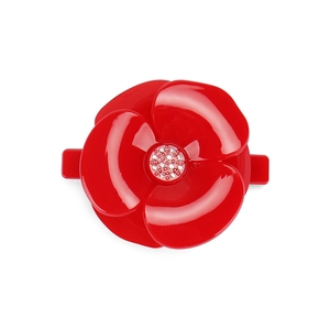Detailed macro view of a red acrylic camellia flower hair clip with sparkling rhinestone center