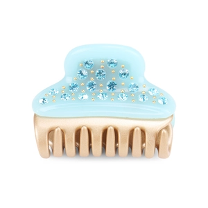 Close-up of light blue acetate hair claw clip with embedded crystals and gold teeth