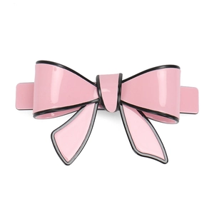 Close-up of a pink acrylic hair clip with black hand-painted edges and spring base